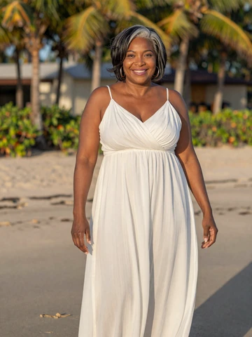 Grace, 50, an elegant black woman on a beach at golden hour